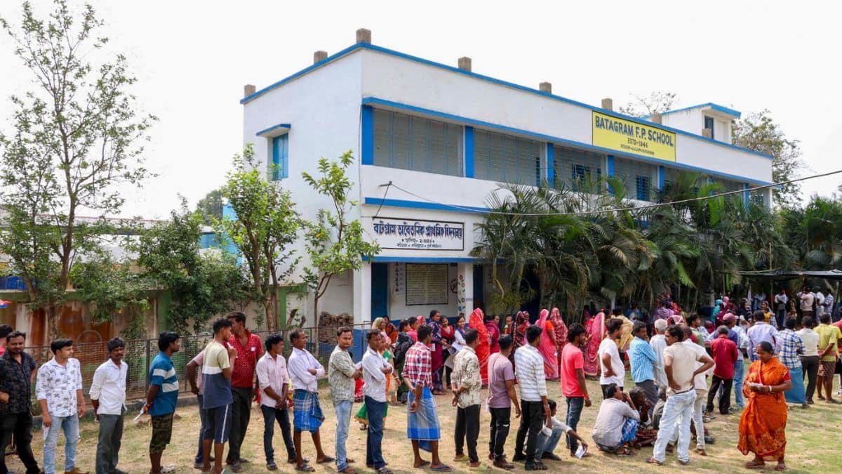 People wait in queues to cast votes at a school being used as a polling booth during the West Bengal Assembly elections, at Batagram, East Burdwan district, on Wednesday ( Image : PTI)